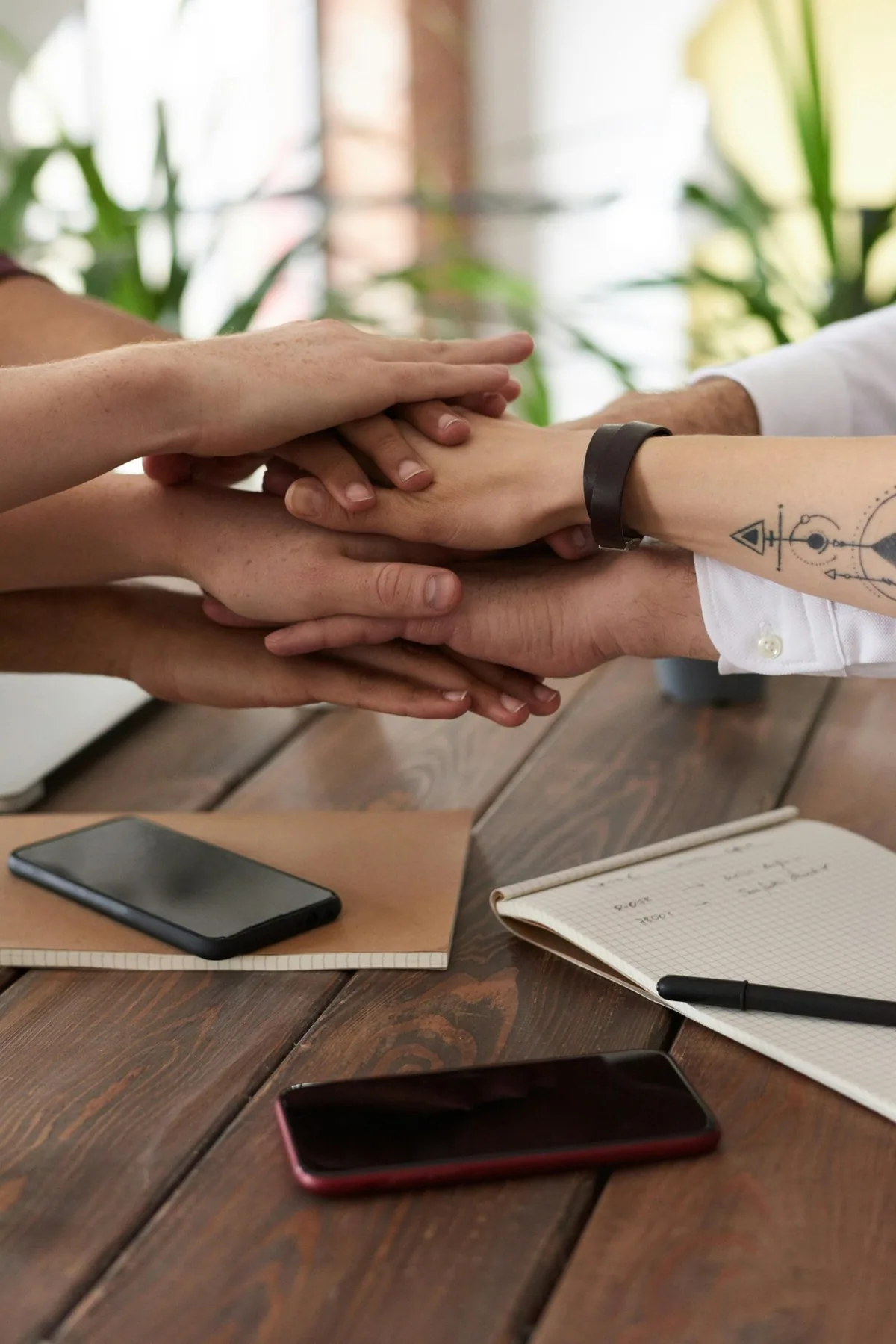Hands collaborating at a table, an illustrative business photograph