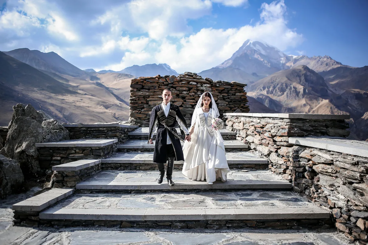 Wedding couple in a Georgian mountain landscape, an illustrative photograph