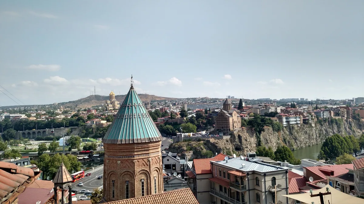 Sunny panorama of Old Tbilisi, its river and hillside neighbourhoods